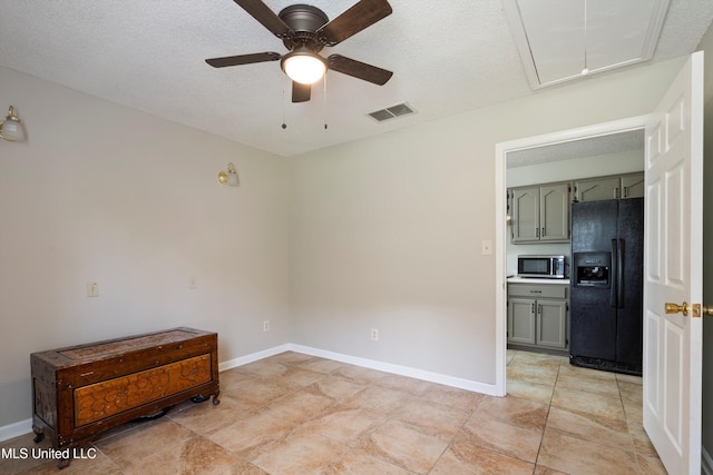 3590 Shady Oaks Dr, Olive Branch, MS 38654 - empty room featuring attic access, ceiling fan, a textured ceiling, baseboards, and light tile patterned floors