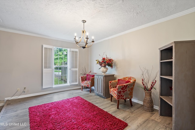 3590 Shady Oaks Dr, Olive Branch, MS 38654 - living area featuring a chandelier, a textured ceiling, crown molding, wood finished floors, and baseboards
