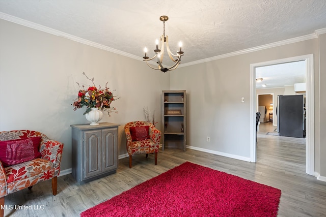 3590 Shady Oaks Dr, Olive Branch, MS 38654 - living area featuring a chandelier, wood finished floors, baseboards, crown molding, and a textured ceiling