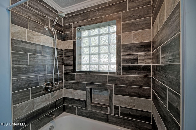 bathroom featuring ornamental molding and tiled shower / bath