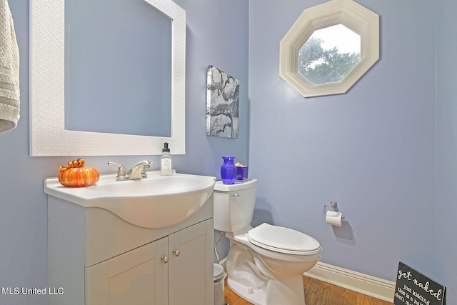 bathroom with vanity, hardwood / wood-style flooring, and toilet