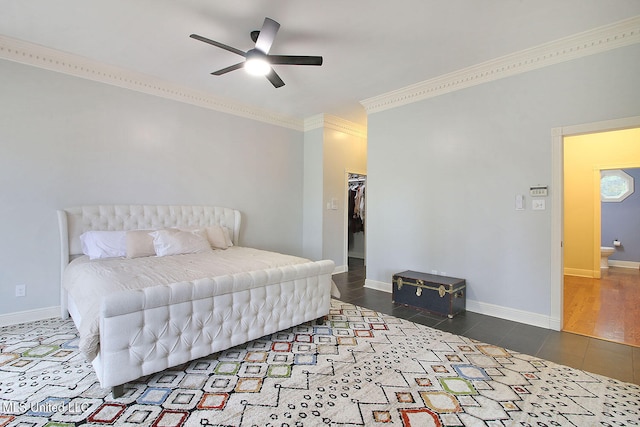 bedroom with ceiling fan, hardwood / wood-style floors, a walk in closet, a closet, and ornamental molding