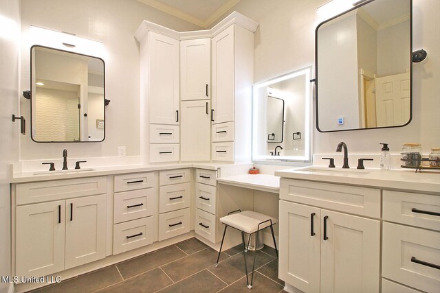 bathroom featuring tile patterned flooring, vanity, and crown molding