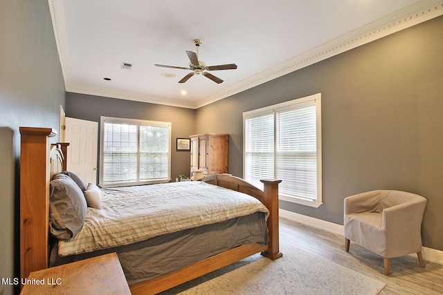 bedroom featuring light wood-type flooring, ceiling fan, and crown molding