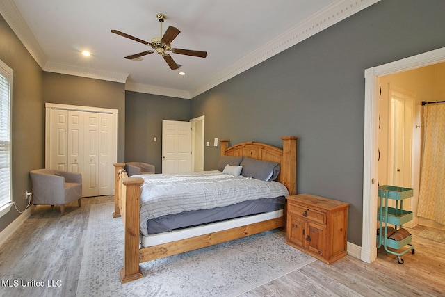 bedroom with light wood-type flooring, ornamental molding, ceiling fan, multiple windows, and a closet