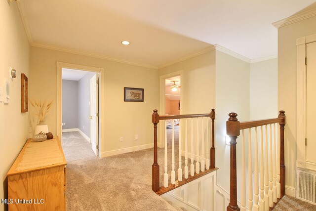 corridor featuring light carpet and crown molding