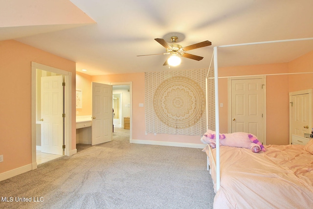 bedroom with a closet, light colored carpet, ceiling fan, and ensuite bathroom