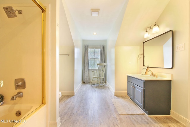 bathroom featuring bathing tub / shower combination, vanity, and hardwood / wood-style flooring