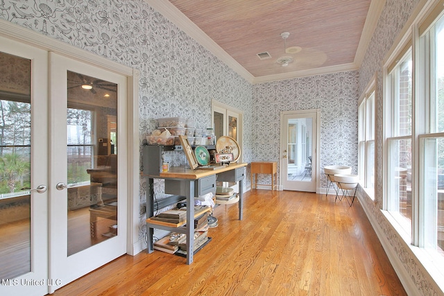 interior space with light wood-type flooring, ornamental molding, wood ceiling, and french doors