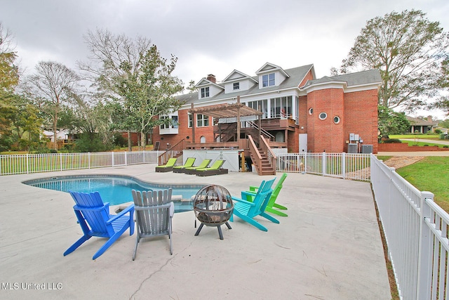 view of pool featuring a patio, a fire pit, a pergola, and a wooden deck