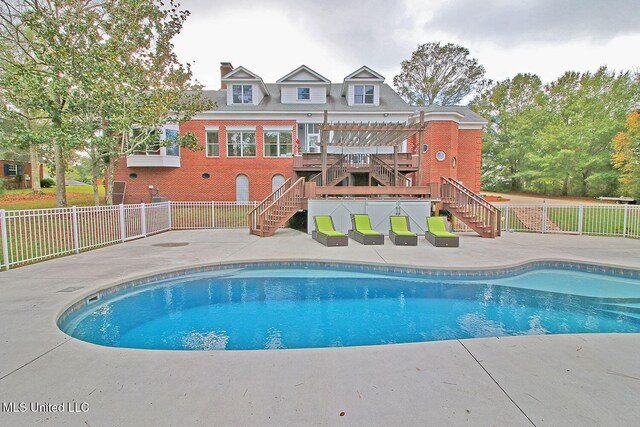 view of pool with outdoor lounge area, a pergola, and a patio