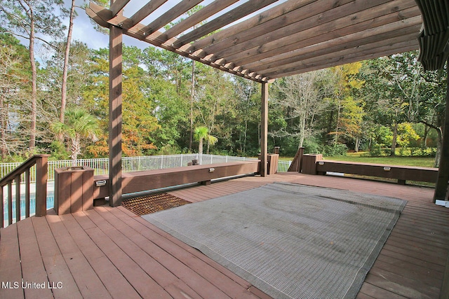 wooden deck featuring a pergola and a swimming pool