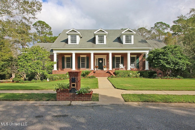 cape cod house featuring a front lawn