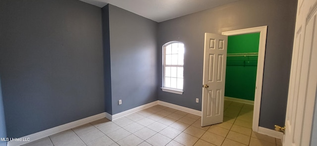 tiled empty room with a healthy amount of sunlight