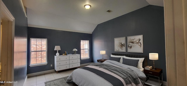 tiled bedroom featuring lofted ceiling