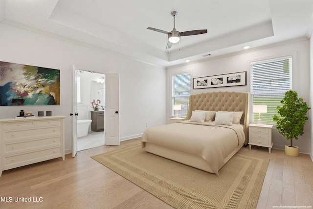4406 John Wood Ln, Olive Branch, MS 38654 - bedroom featuring a tray ceiling, light wood-style floors, connected bathroom, recessed lighting, and ceiling fan