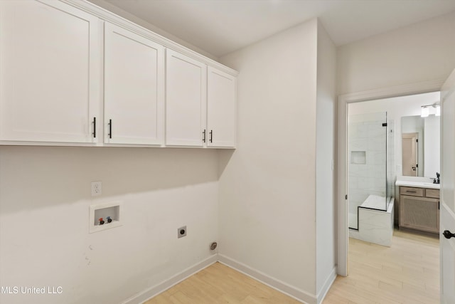 4406 John Wood Ln, Olive Branch, MS 38654 - laundry area featuring cabinet space, hookup for an electric dryer, washer hookup, and light wood-style floors