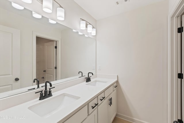 4406 John Wood Ln, Olive Branch, MS 38654 - bathroom featuring double vanity and baseboards