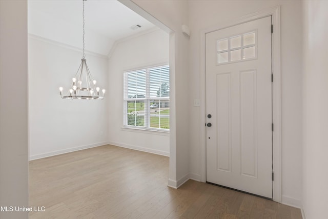 4406 John Wood Ln, Olive Branch, MS 38654 - foyer entrance with a chandelier, light wood finished floors, and lofted ceiling