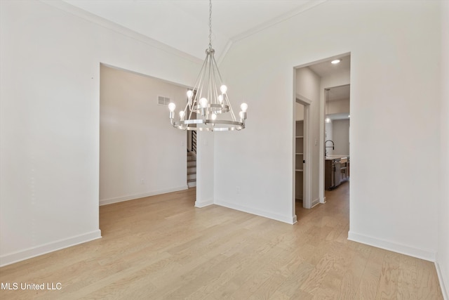 4406 John Wood Ln, Olive Branch, MS 38654 - unfurnished dining area with ornamental molding, a chandelier, light wood-style floors, and stairs