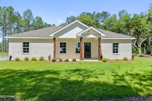 view of front of property featuring a front lawn and brick siding