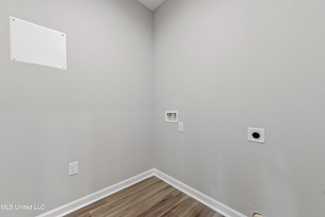 washroom featuring electric dryer hookup, hookup for a washing machine, wood finished floors, and baseboards