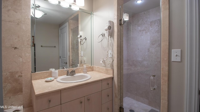 bathroom featuring a shower stall and vanity