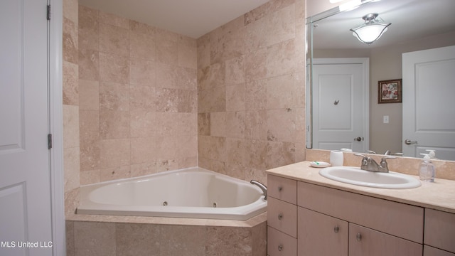 bathroom with a jetted tub and vanity