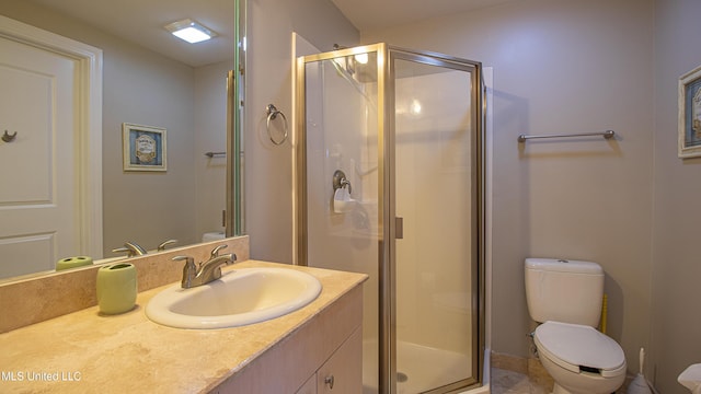 bathroom featuring vanity, toilet, and a stall shower