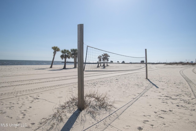 view of community with volleyball court and a water view