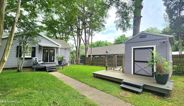 view of yard with a wooden deck and a storage unit