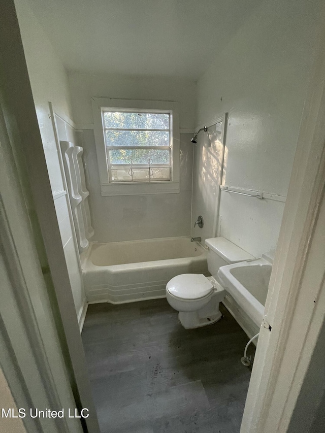 full bathroom with hardwood / wood-style flooring, shower / tub combination, toilet, and sink