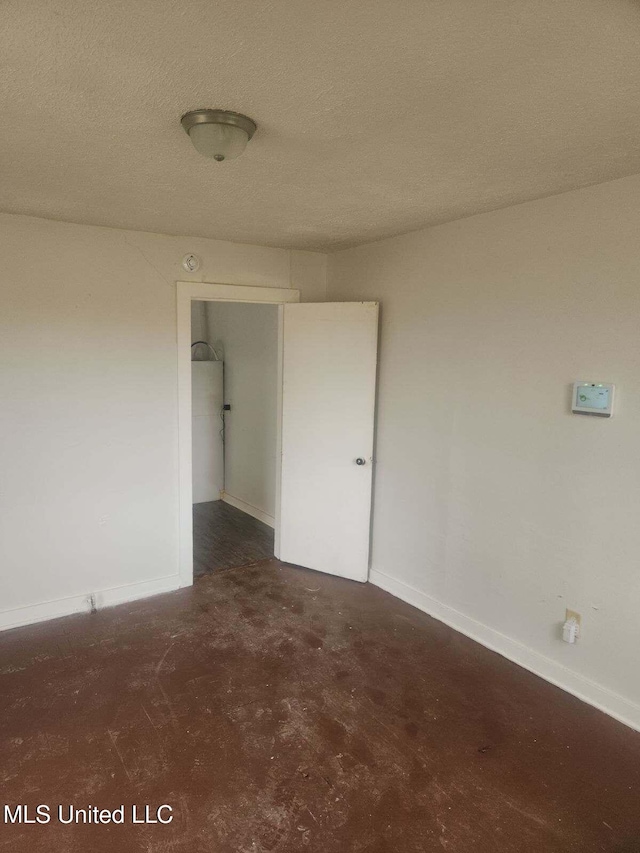 spare room with a textured ceiling