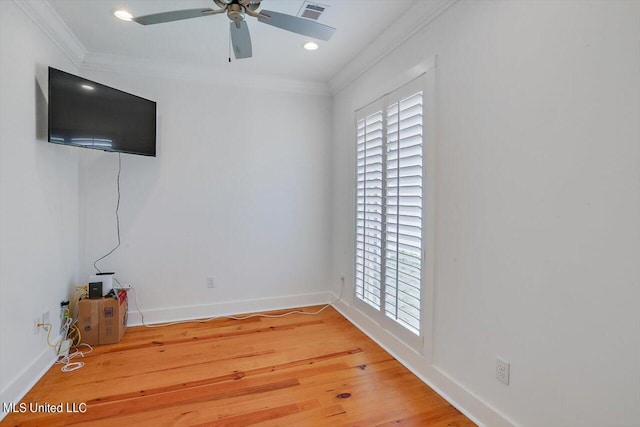 empty room featuring crown molding, wood-type flooring, and ceiling fan