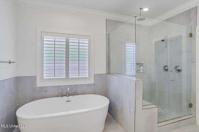 bathroom featuring independent shower and bath, ornamental molding, and tile walls