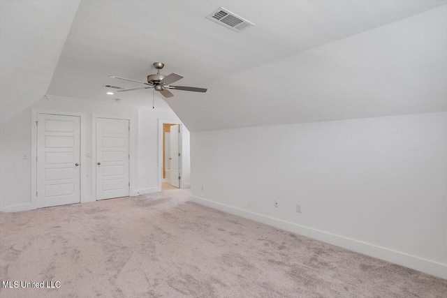 additional living space with light carpet, ceiling fan, and vaulted ceiling