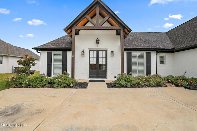 property entrance featuring a patio area and french doors