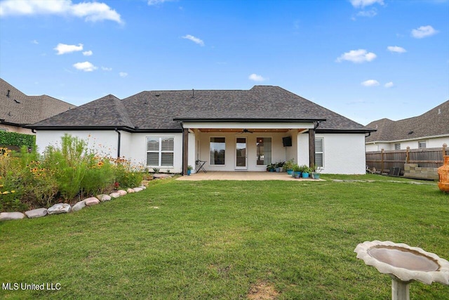 rear view of property with a yard and a patio area