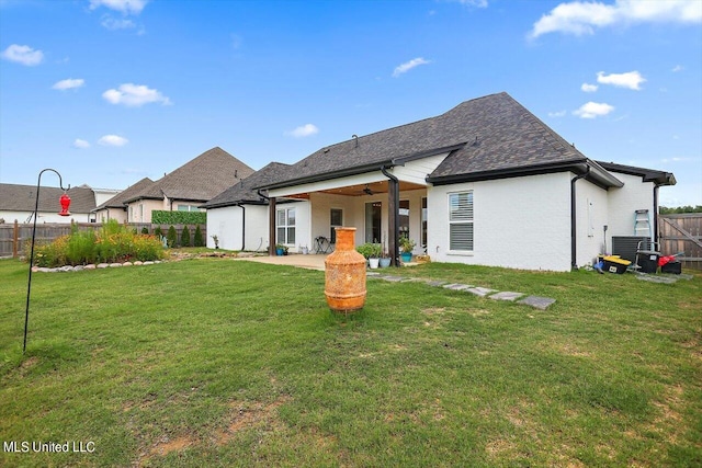 rear view of house with a yard and a patio area