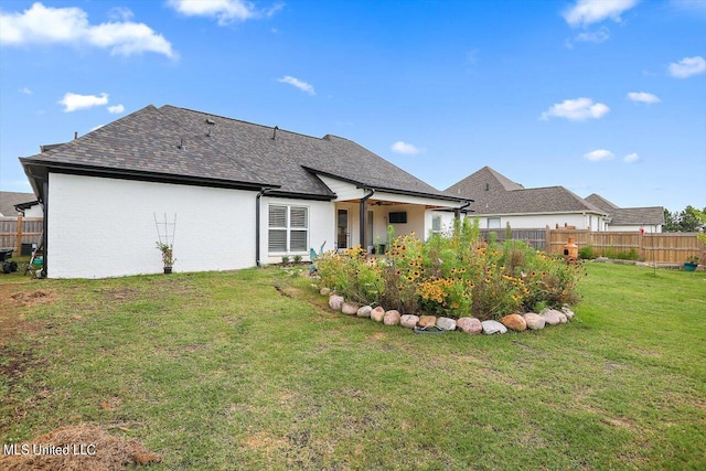 rear view of house with a yard