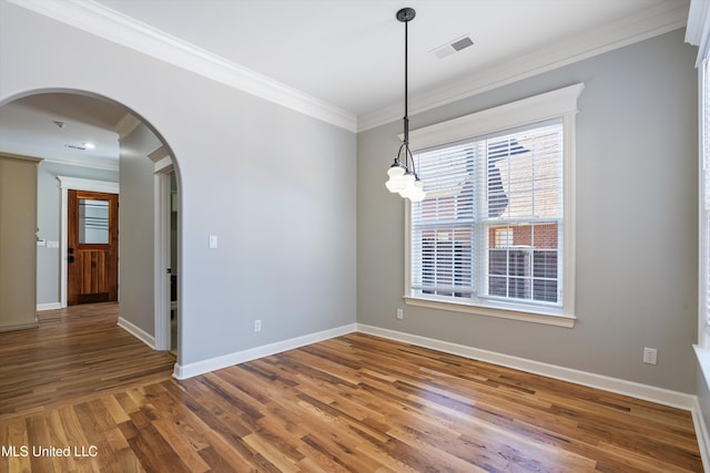 empty room featuring hardwood / wood-style flooring and crown molding