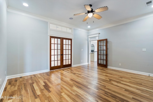 spare room featuring hardwood / wood-style flooring, ornamental molding, and french doors