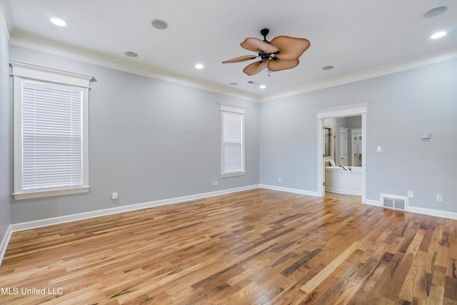 spare room featuring light hardwood / wood-style flooring, ornamental molding, and ceiling fan