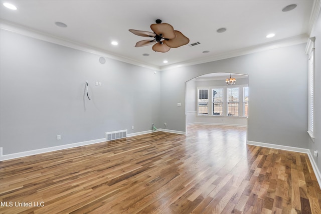 unfurnished living room with crown molding, ceiling fan with notable chandelier, and hardwood / wood-style floors