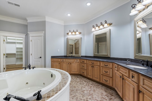 bathroom with crown molding, vanity, and tiled bath