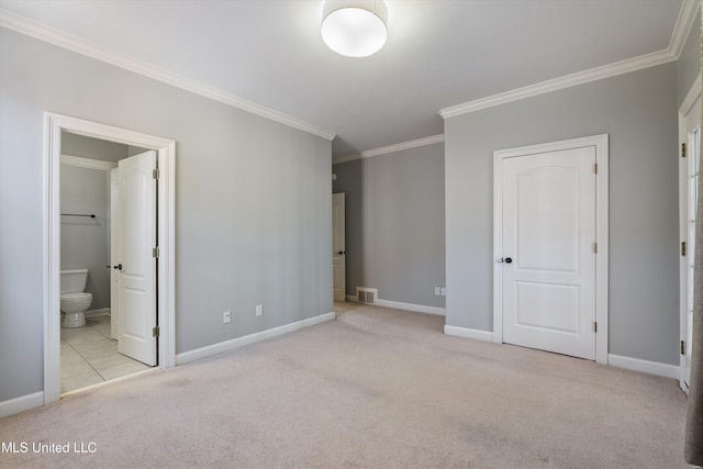 unfurnished bedroom with ensuite bath, ornamental molding, and light colored carpet