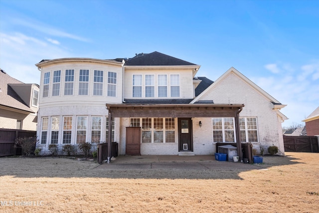 rear view of property with a yard and a patio area