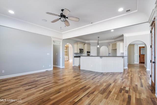 unfurnished living room with crown molding, ceiling fan, and light hardwood / wood-style flooring