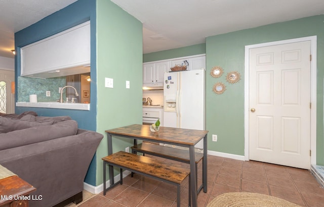 dining room featuring tile patterned floors and sink