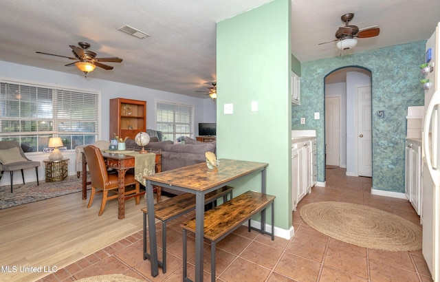 tiled dining area featuring a textured ceiling